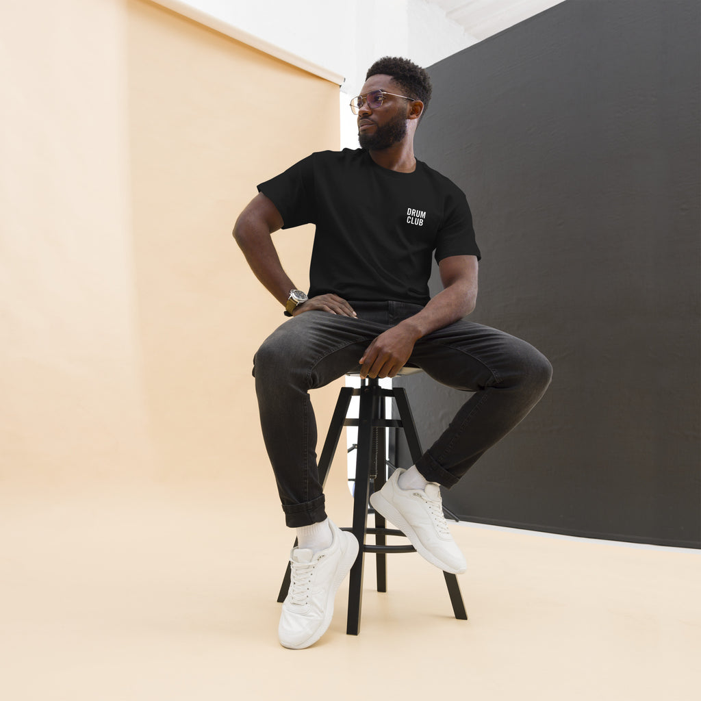 Shop the Drum Club Tee from Drum Club Global. Premium black unisex drummer apparel with a clean white left chest mark — built for percussionists who move with intention.