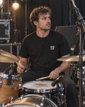 Drummer wearing the black DRUM CLUB Classic Tee during a rehearsal or soundcheck.